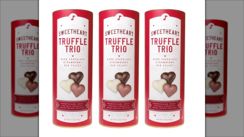 Three canisters of A'cappella SweetHeart Truffles side-by-side on a white background