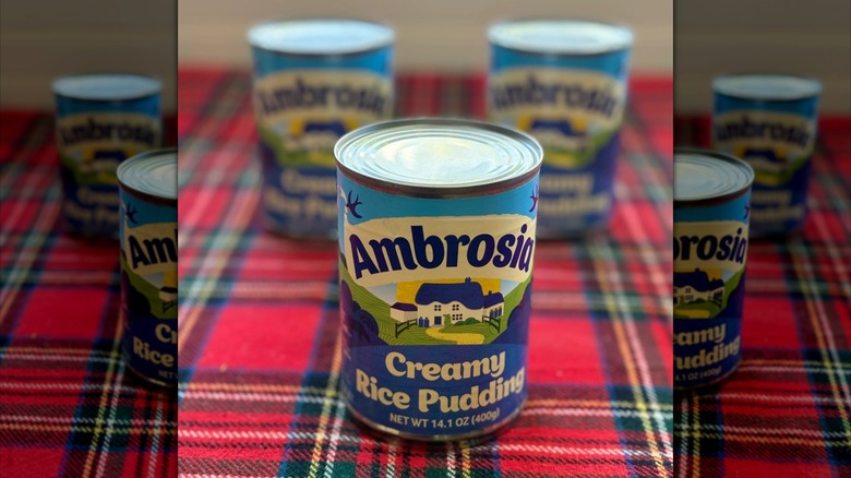 Cans of Ambrosia Creamy Rice Pudding on a plaid cloth