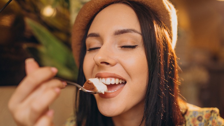 woman eating tiramisu