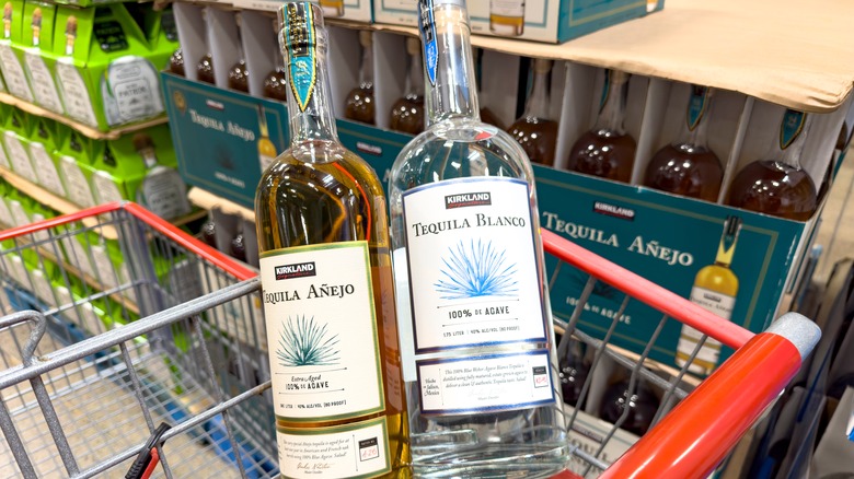 Bottles of Kirkland Signature tequila in grocery cart