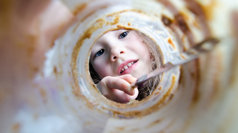 child looking in empty jar