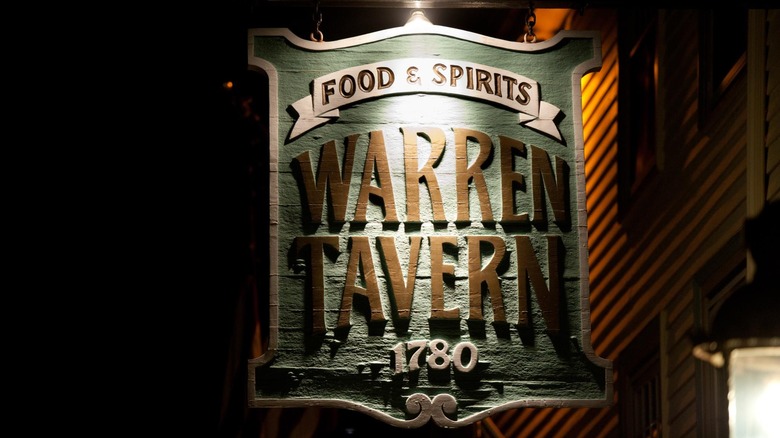 Warren Tavern exterior with sign, nighttime