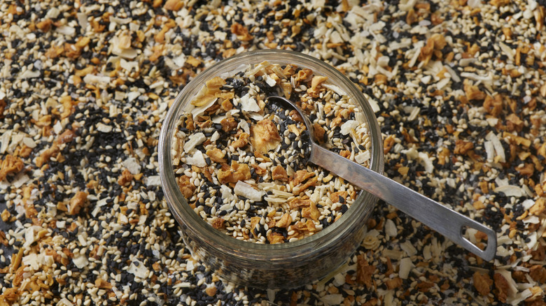 A jar of everything bagel seasoning with a spoon sticking out of it