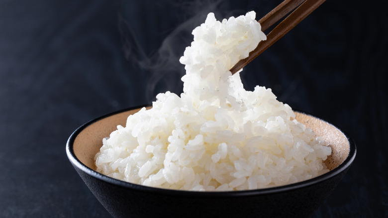 A bowl of plain white rice with chopsticks