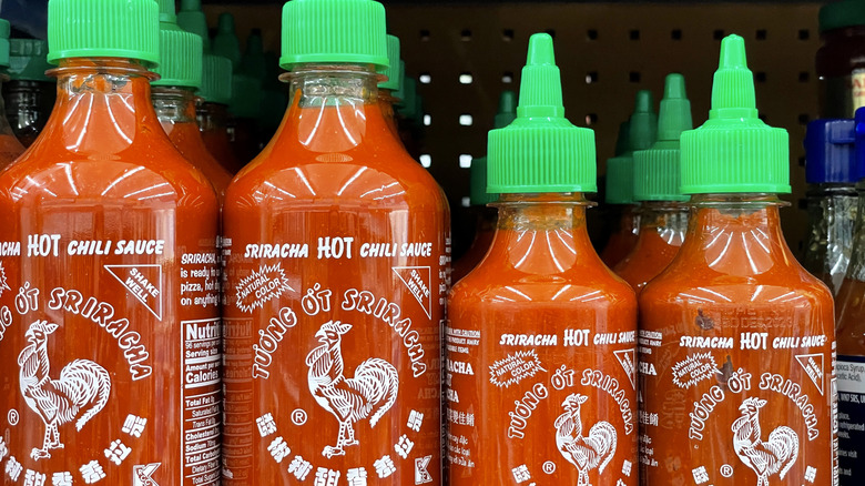Bottles of sriracha on a shelf