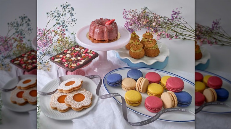 The contents of the Mother's Day French Sweets Box arranged on serving dishes near bunches of dried flowers