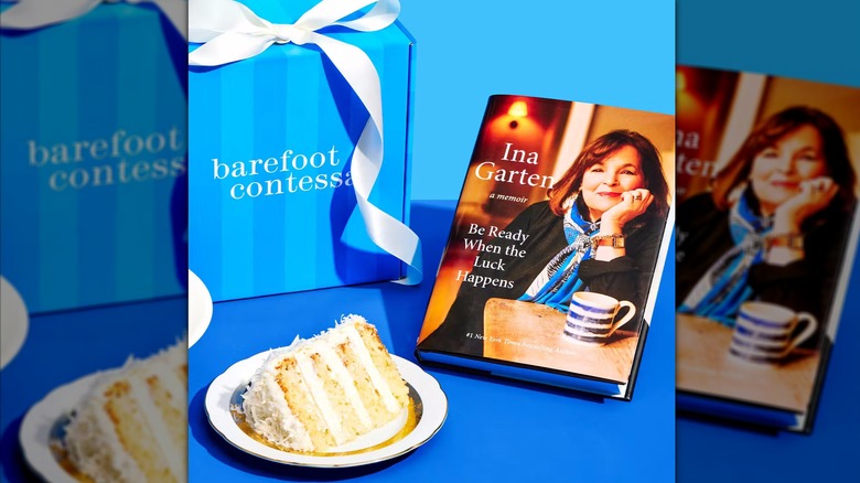 A slice of Ina Garten coconut cake sits next to a gift box and the star's memoir.
