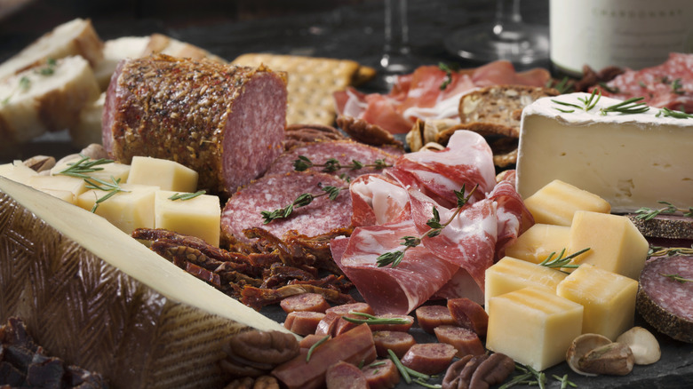 Sliced prosciutto on a charcuterie board
