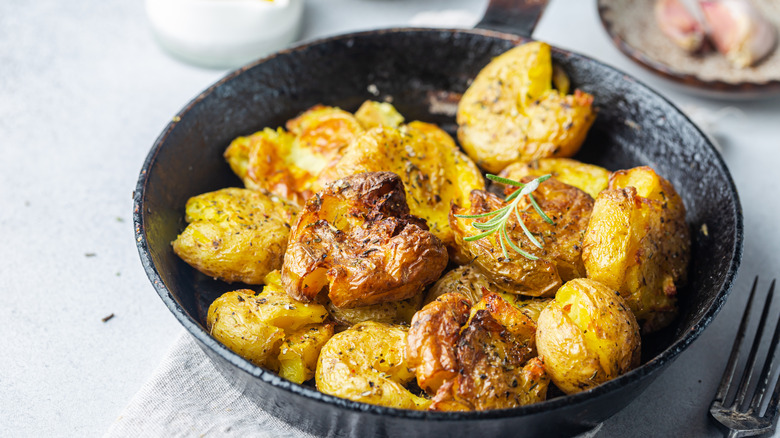 smashed fried potatoes in pan