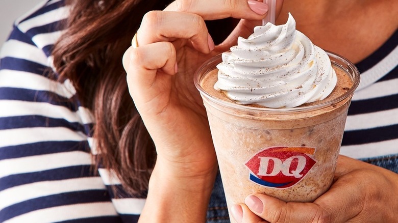 Woman holding Dairy Queen milkshake