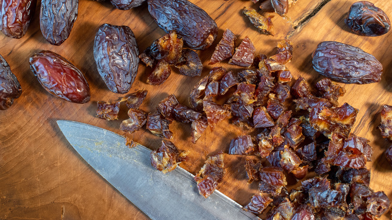 chopped dates and knife on board