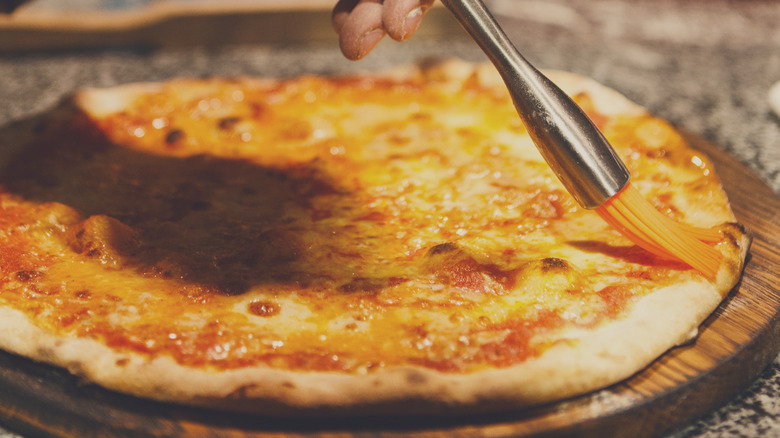 Brushing butter on pizza crust