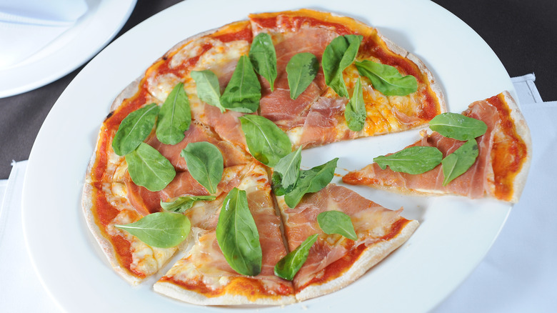 Ham pizza with fresh basil