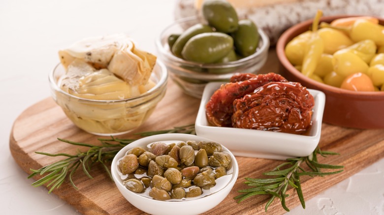Various marinated toppings on board