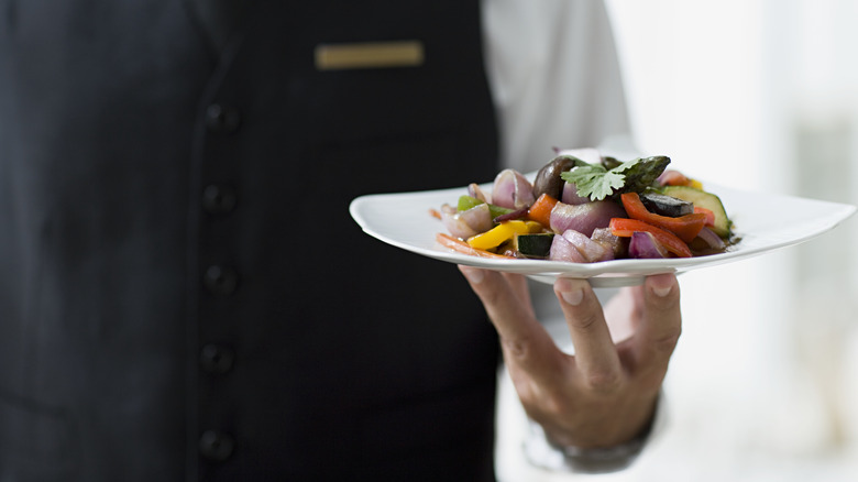 waiter holding a dish