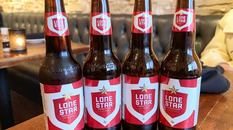Bottles of Lone Star lined-up on a bar table