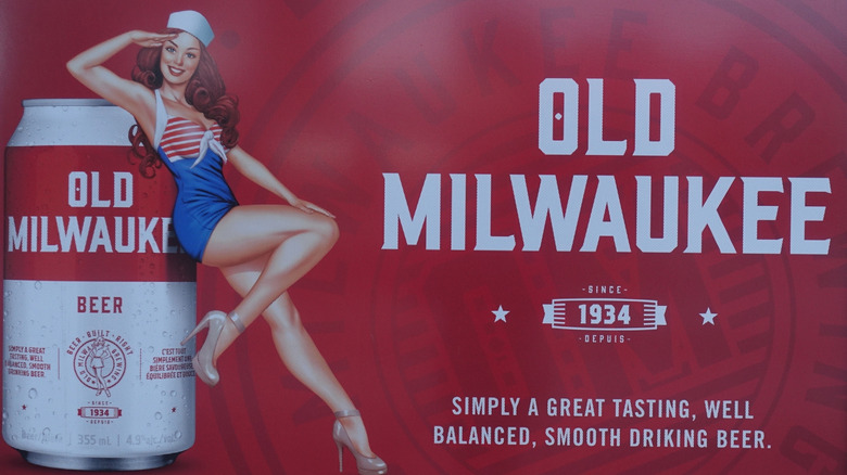 Old Milwaukee advertisement with a woman in a sailor costume leaning on a can of the beer