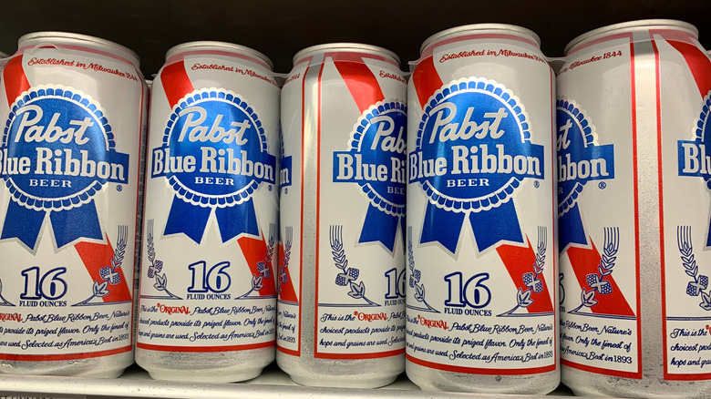 Pabst Blue Ribbon tallboy cans on display in a store