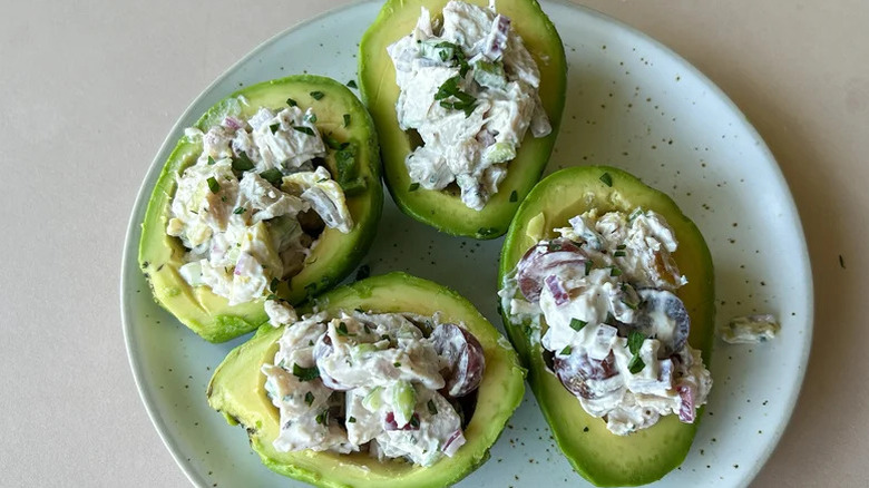 Avocados stuffed with chicken salad on plate
