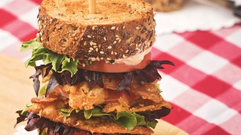 Stacked BLT sandwich on checkerboard tablecloth
