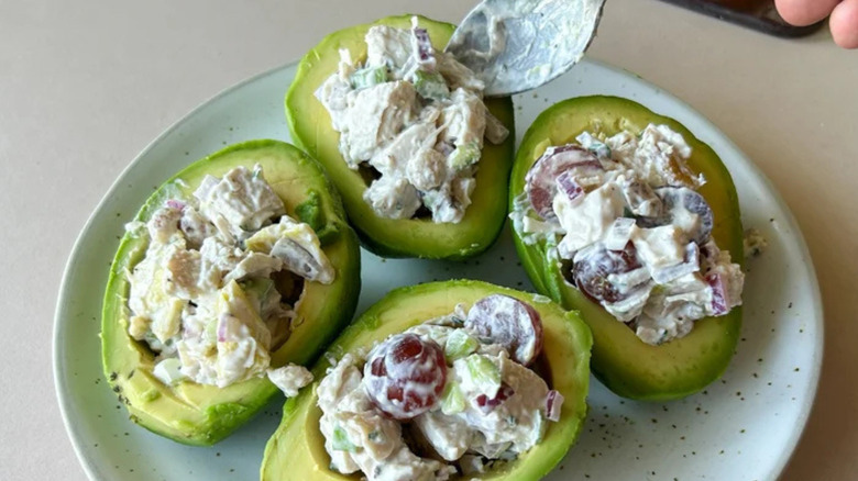 Avocados stuffed with chicken salad on plate
