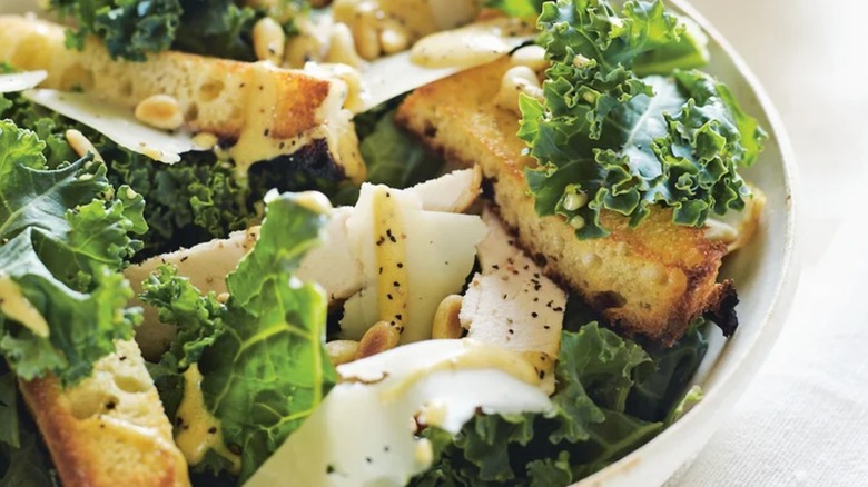 Kale Caesar salad in a bowl with croutons