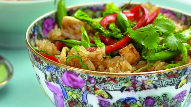 Colorful bowl of fried rice with cilantro and chile