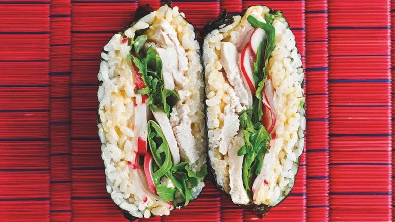 Chicken onigirazu on a red bamboo mat