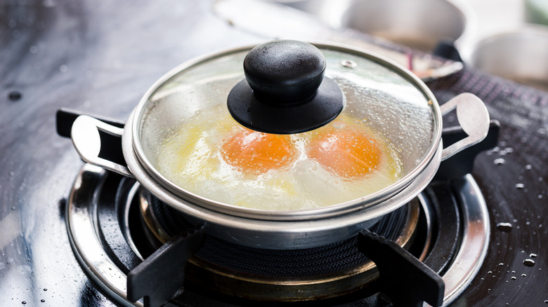 fried eggs in covered pan