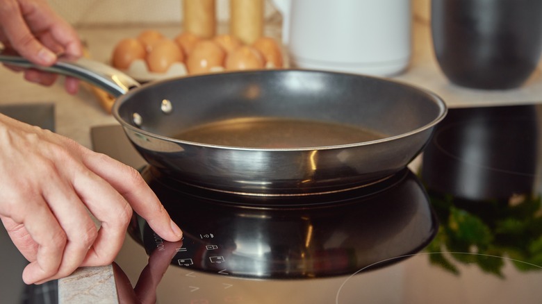 person turning on stove
