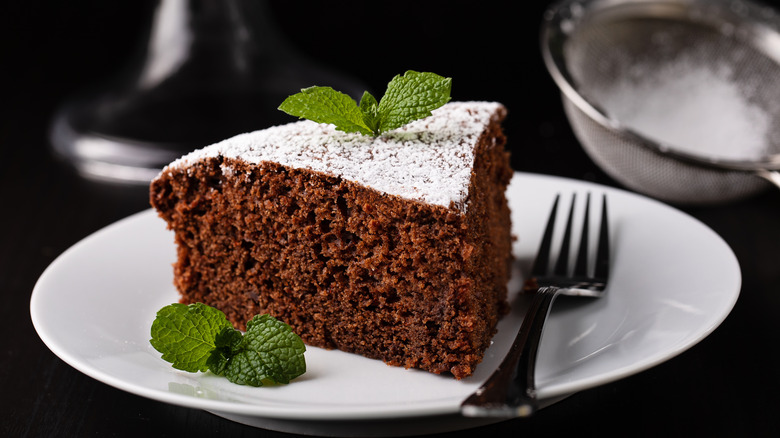 chocolate cake with powdered sugar on plate