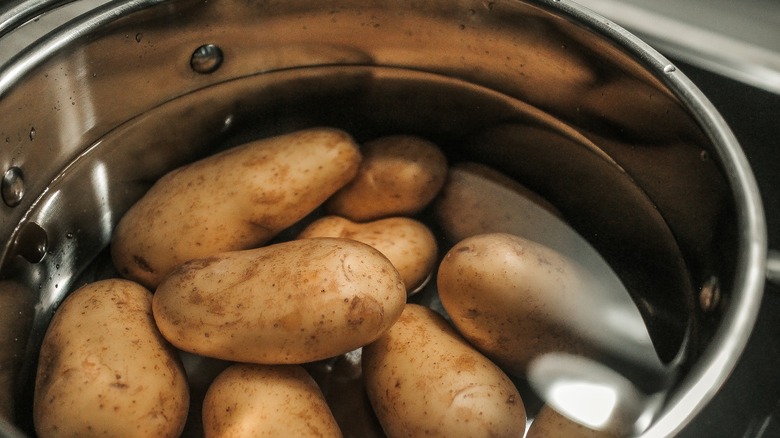 unpeeled potatoes in cold water