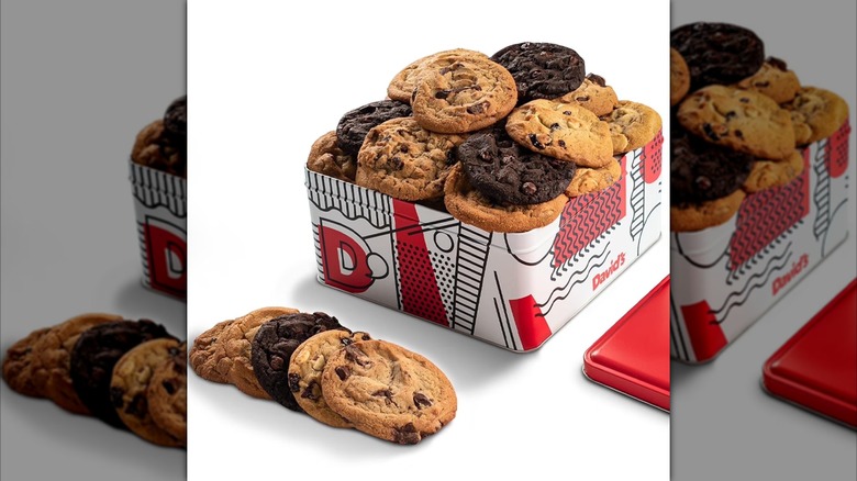 An open David's Cookies Fresh Baked Cookies Gift Tin with cookies set out to the side.