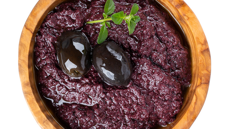 Olive tapenade in wooden bowl