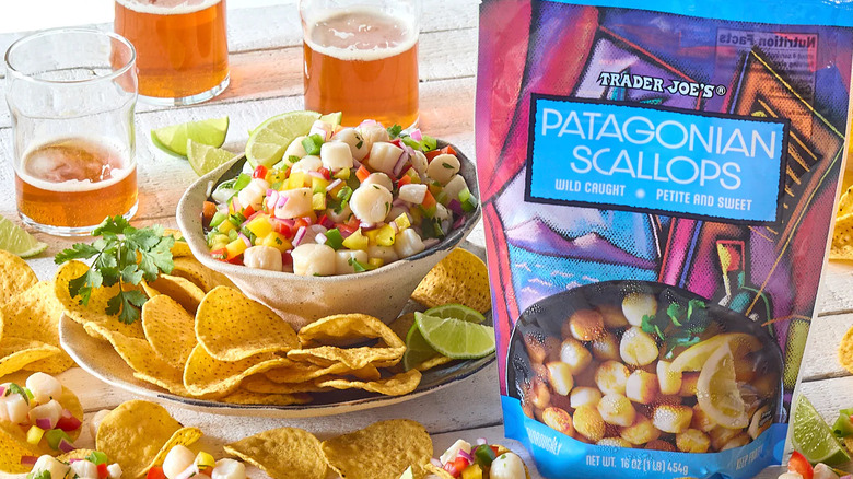 A bag of Trader Joe's Patagonian Scallops near a dish of prepared food and drinks.
