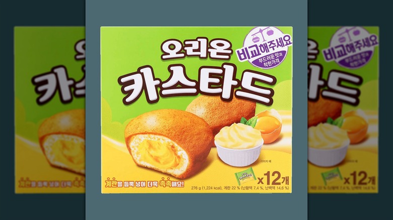 A 12-pack of Orion Custard cakes against a gray background.