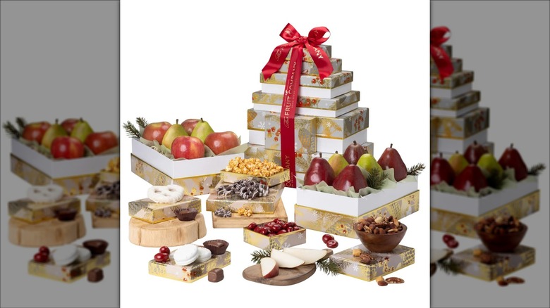 A Celebration 8-Box Tower from The Fruit Company is surrounding by opened boxes of treats