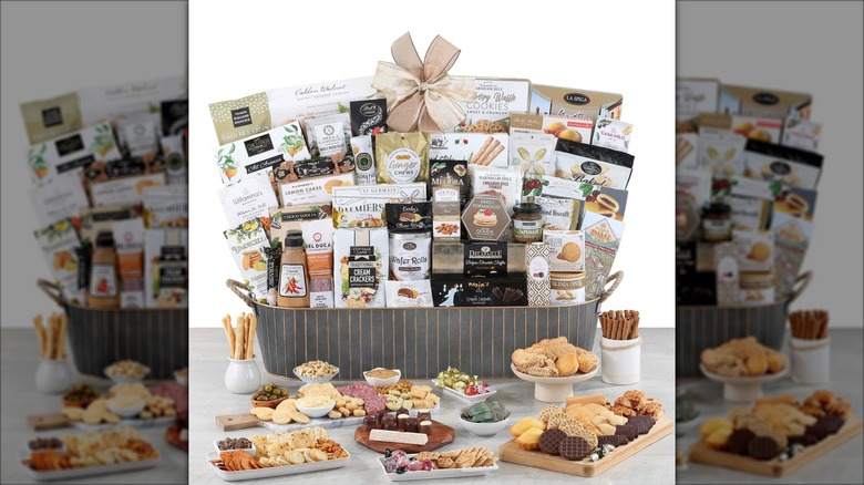 A Grand Traditions Gift Basket sits on a countertop with assorted goodies spread around it