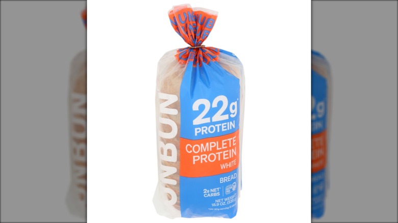 A package of Unbun Complete Protein White Bread against a white background.