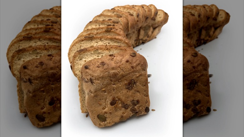 A loaf of BeyondChipz The Ultimate Low Carb Bread Seriously Seeded bread is arranged domino-style.