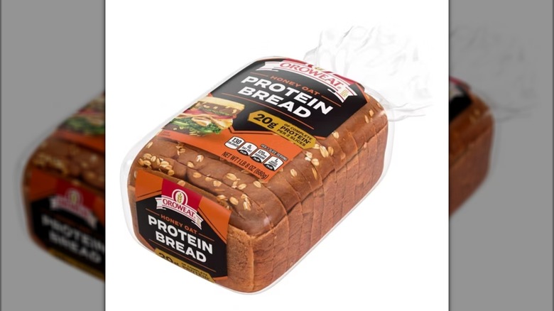 A loaf of Oroweat Protein Honey and Oat Wide Pan Bread against a white background.