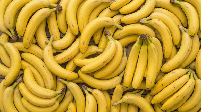 Bunches of yellow bananas piled together