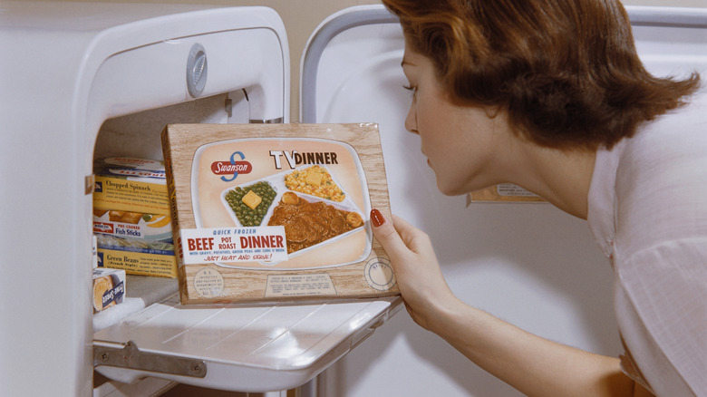 Someone pulls a Swanson TV Dinner from the freezer