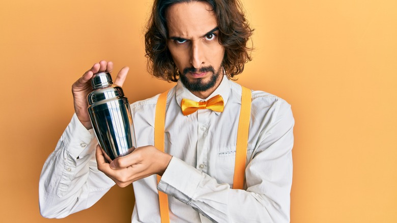 frustrated bartender with cocktail shaker 