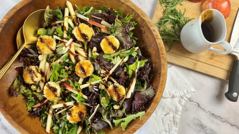 Large wooden bowl of breaded goat cheese salad