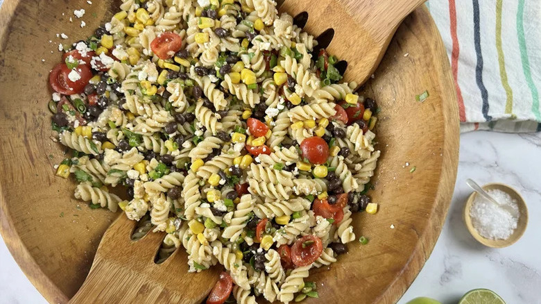 Large wooden bowl of Southwestern pasta salad with fresh veggies
