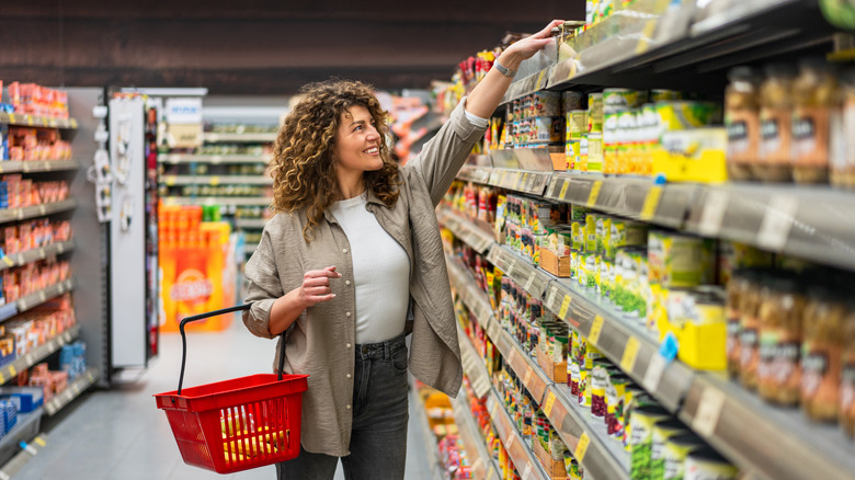 Woman reaching for an item at grocery store