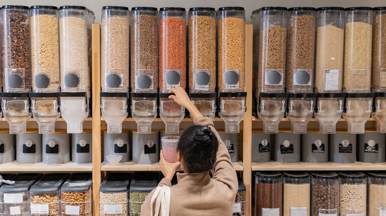 Women filling container from bulk bin