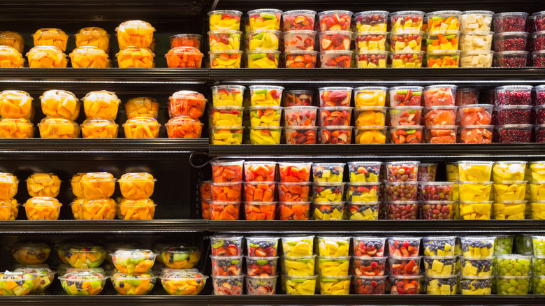 Sliced fruit in containers at grocery store