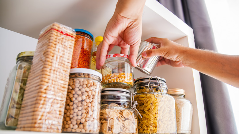 Man organizing kitchen pantry